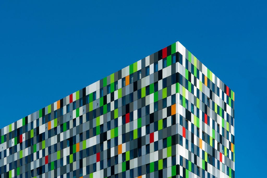 Panel lamination being applied to the exterior of a building façade.